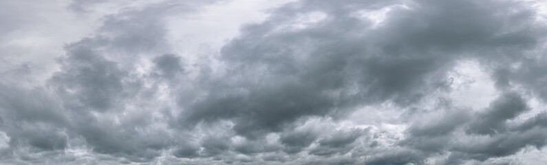 dramatic dark clouds before rain and thunderstorm. wide panoramic image.