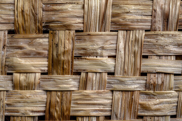 Woven bamboo paper texture with interlaced fibers and natural tones.