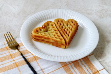 Heart shape of Plain Croissant Waffle or Croffle served in white plate