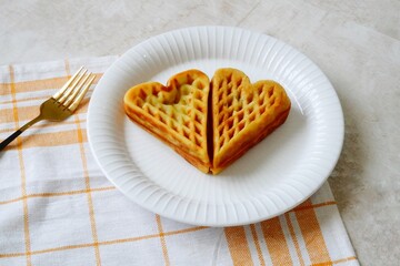 Heart shape of Plain Croissant Waffle or Croffle served in white plate
