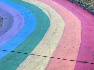 a photography of a rainbow painted sidewalk with a fire hydrant. - Powered by Adobe
