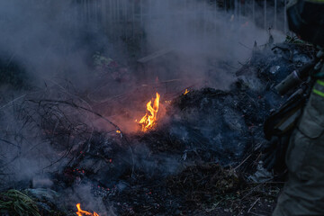 Burning trash pile of flames.