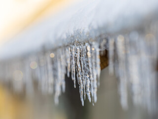 Transparent icicle on a gray background with copy space