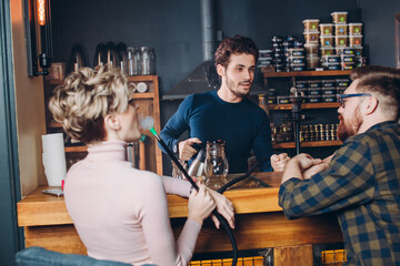 kind friendly barmen is talking with visitors at the cafe. close up shot. friendly atmosphere in...