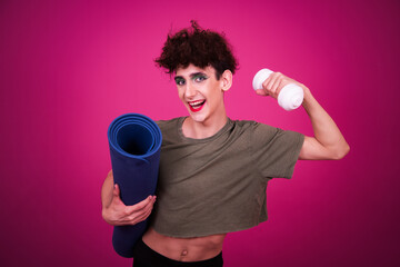 A funny guy in make-up is doing fitness. retro style. Pink background.