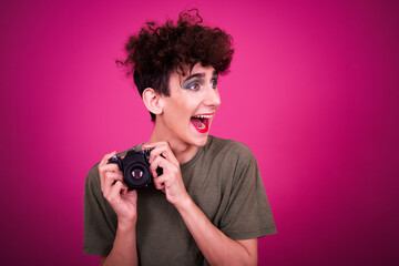 Funny guy dressed as a drag queen and online dating. Pink background.