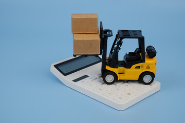 Yellow forklift truck carrying carton boxes and calculator on blue background.
