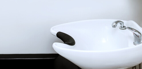 Sink in a beauty salon for washing hair and hair. Horizontal banner