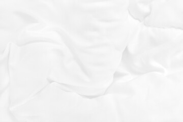 Obraz premium Close up top view of white bedding sheet and wrinkle messy blanket in bedroom after wake up in the morning.