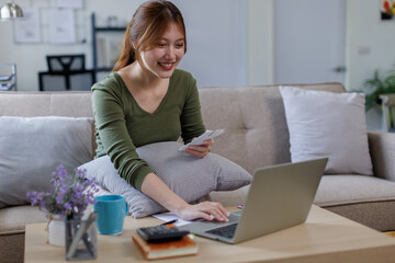 Business Asian woman using calculator for do math finance on wooden desk at home and business working background, tax, accounting, statistics and analytic research concept