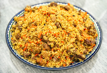 national dish of oriental cuisine of Central Asian countries pilaf (plov) with pork and beef meat...