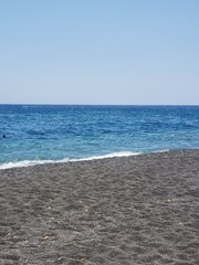 Black beach and sea