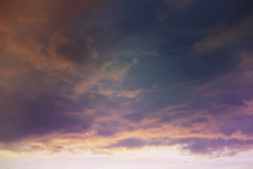 Beautiful sunset sky above clouds with dramatic light. Cabin view from airplane