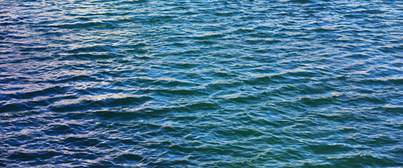 Water surface. The texture of the water. Waves on the lake in windy weather.