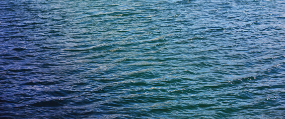 Water surface. The texture of the water. Waves on the lake in windy weather.