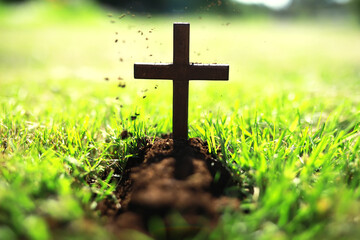 Concept conceptual black cross religion symbol silhouette in grass