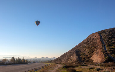 Hot air balloon in the early morning golden hour over the Temecula Valley in southern California United States