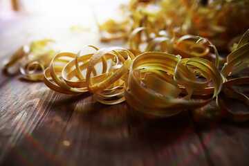 Hand planer with wooden sawdust. On a wooden background. High quality photo