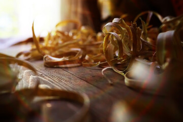 Hand planer with wooden sawdust. On a wooden background. High quality photo