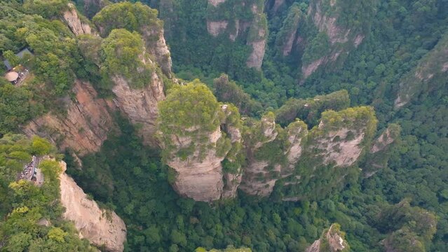 Overhead push in view over Avatar Hallelujah Mountain with reveal shot of karst formation columns in Zhangjiajie National Forest Park at sunset. Tracking shot with Avatar Hallelujah Mountain, China
