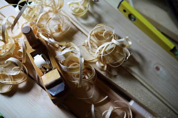 Plane jointer carpenter or joiner tool and wood shavings. Woodworking tools on wooden table....