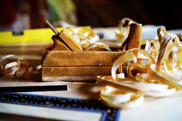 Hand planer with wooden sawdust. On a wooden background. High quality photo