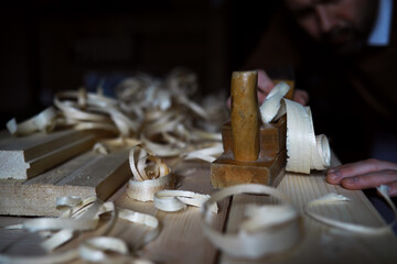 Plane jointer carpenter or joiner tool and wood shavings. Woodworking tools on wooden table....