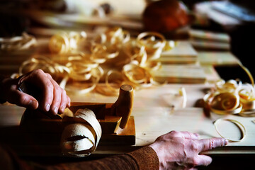 Hand planer with wooden sawdust. On a wooden background. High quality photo