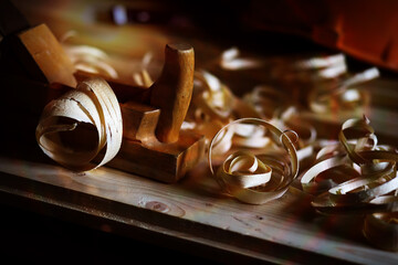 Hand planer with wooden sawdust. On a wooden background. High quality photo