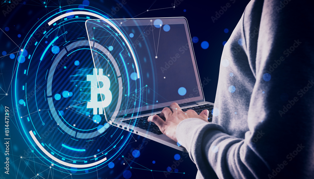 Poster Close up and side view of hands using laptop with glowing round bitcoin hologram with polygonal mesh and bokeh circles on blurry blue background. Digital banking, money and finance concept.