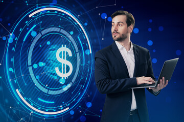 Attractive thoughtful young european businessman with laptop and glowing round dollar hologram with mesh and bokeh circles on blue background. Digital banking, money and finance concept.