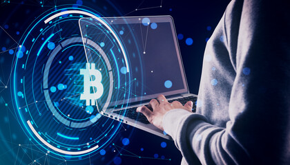 Close up and side view of hands using laptop with glowing round bitcoin hologram with polygonal mesh and bokeh circles on blurry blue background. Digital banking, money and finance concept.