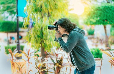 Male photographer taking photos in a public park, Nagarote. Photographer taking photos on the street