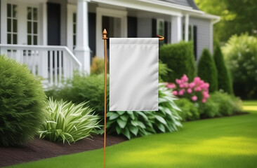 Blank garden flag on green grass on the house background. Garden flag mockup