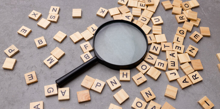 Magnifying glass with many wood letters of English alphabets, learning English concept