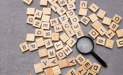Magnifying glass with many wood letters of English alphabets, learning English concept