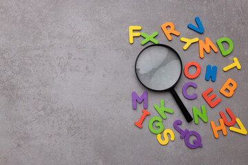 Magnifying glass with many wood letters of English alphabets, learning English concept