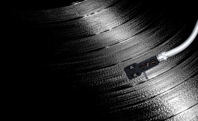 Vinyl record with turntable arm rotating in a macro shot