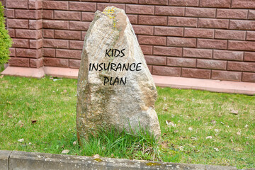 KIP kids insurance plan symbol on the stone near the fence on the grass