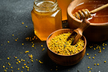 Flower bee pollen in a wooden bowl. Beekeeping products. Top view.