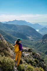 Fototapeta premium A woman hiking in the mountains, Serrella peak Quatretondeta, Alicante, Spain - stock photo