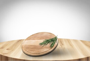 Cutting wooden board with green herbs