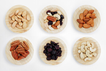 set of wooden bowls of nuts on white background