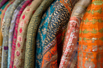 A vibrant display of textile arts showcasing intricate patterns and diverse fabric techniques, exemplifying traditional and contemporary craftsmanship 