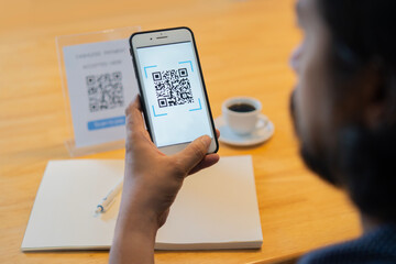 Man scanning tag in Coffee shop accepted generate digital pay without money