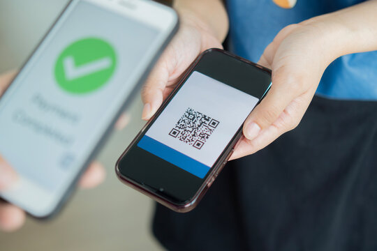Selective focus of hand holding phone and scanning qr code. QR code payment and cash technology concept.