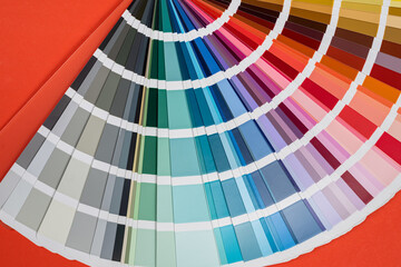 Paper rainbow color palette guide isolated on red background