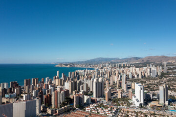 Aerial drone photo of the beautiful city of Benidorm in Spain in the summer time showing high rise...