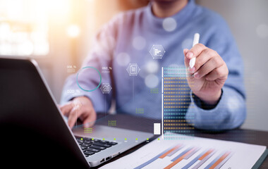 Businessman using computer for development and Analytics Data technology management System for report marketing strategy planning. graph analysis and information on a futuristic virtual screen.