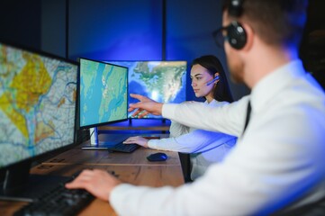 Center of dispatching maintenance. Portrait of cheerful woman and man working via headset...